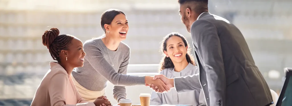 Shaking hands during a meeting in an office